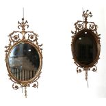 A Pair of Giltwood and Gesso Oval Mirrors, late 19th/early 20th century, the moulded frames