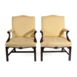 A Pair of 19th Century Carved Mahogany Library Armchairs, in George III style, recovered in yellow