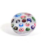 A Clichy Spaced Millefiori Paperweight, circa 1850, set with sixteen canes on a white gauze