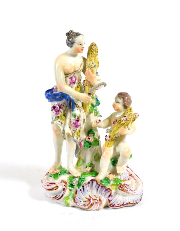 A Bow Porcelain Figure Group of Summer, circa 1765, modelled as a classical maiden holding a sheaf