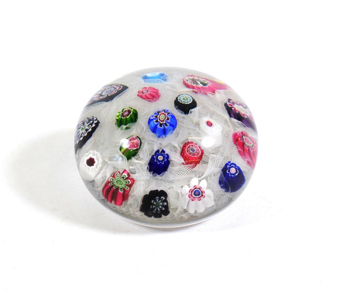 A Clichy Spaced Millefiori Paperweight, circa 1850, set with nineteen canes on a white gauze ground