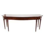 A George III Mahogany Serpentine Shaped Serving Table, early 19th century, with plain frieze and