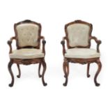 A Pair of Mid 19th Century Walnut Armchairs, recovered in light beige close-nailed and buttoned