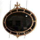 A 19th Century Gilt and Gesso Adam Style Oval Mirror, the acanthus decorated frame surmounted by