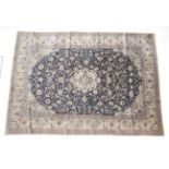 Nain Part Silk Carpet Central Iran, circa 1960 The indigo field of scrolling vines around a