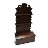 An Oak Spoon Rack, late 18th century, the scrolled back supporting two racks with apertures for