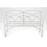 ~ A Regency Wrought Iron Garden Bench, early 19th century, white painted with interlaced lunette