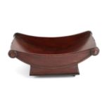A Mahogany Cheese Coaster, early 19th century, of boat shape with scrolled and moulded handles,