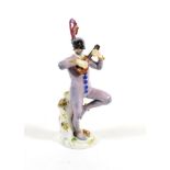 A Meissen Porcelain Figure of Harlequin, 20th century, wearing a feathered cap and mask, standing on