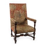 A late 17th Century Walnut Framed Armchair, recovered in close-nailed needlework fabric with green