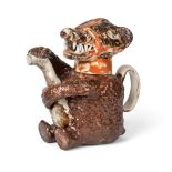 A Staffordshire Pottery Bear Teapot and Cover, circa 1820, the seated animal with brown markings and