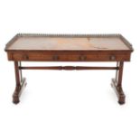~ An Early Victorian Mahogany Writing Table, mid 19th century, the pierced brass three-quarter