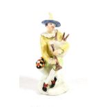 A Bow Porcelain Commedia dell'Arte Figure of Harlequin, circa 1755, sitting on a rock playing