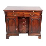 A George III Mahogany Kneehole Desk, circa 1760, the moulded top with a pull-out slide above two
