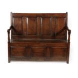 A George III Joined Oak Settle, late 18th century, the back support with four moulded panels and