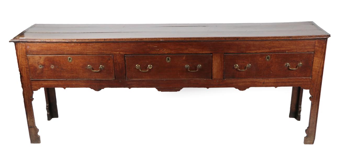 An Early 18th Century Oak Low Dresser, the moulded top with three boards above three frieze drawers,