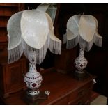 ^ A pair of late 19th century pink and white overlay glass table lamps with gilt metal bases, 81cm