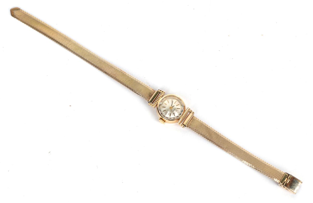 A lady's 14 carat gold wristwatch, signed Tissot, with attached plated bracelet