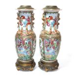 A pair of 19th century Canton Famille rose vases, converted to table lamps with gilt metal mounts