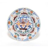 An 18th century Dutch polychrome decorated plate, 22cm diameter