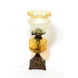 ^ A late Victorian oil lamp with yellow tinted glass reservoir, the metal base in the form of