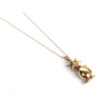 A 9 carat gold articulated gemset cat pendant on a trace link chain with clasp stamped '375',