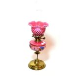 ^ A late Victorian brass oil lamp, with pink floral glass reservoir and pink glass shade, height