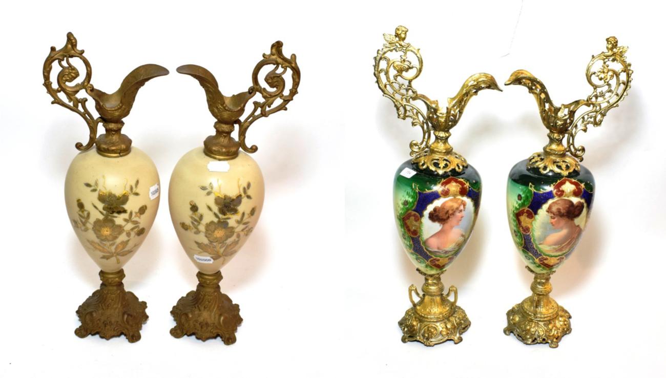 ^ A pair of late 19th century gilt metal ewers, the porcelain bodies decorated with oval portraits