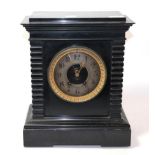 A Victorian black slate mantle clock