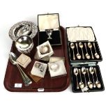 A group of silver items to include cased teaspoons; a pair of George III tablespoons; napkin