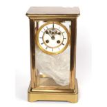 A brass four glass striking mounted clock