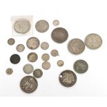 A group of silver coins including two Victorian silver crowns, a 1935 crown, two South African