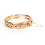 A garnet and rose cut diamond set bangle, stamped '9' '.375', measures 6cm by 4.8cm. Gross weight