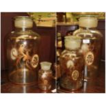 ^ A graduated set of four glass and gilt decorated storage jars with lids, the largest 46cm