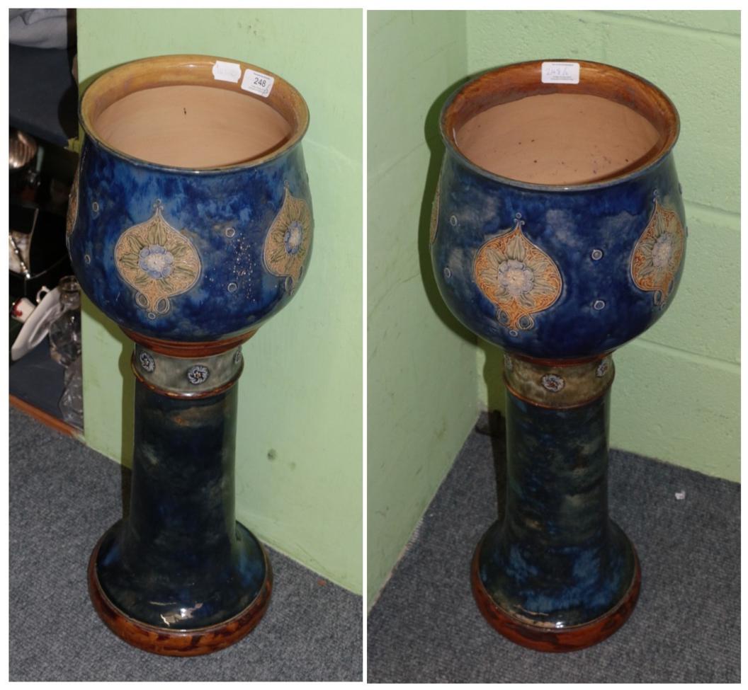 A pair of Royal Doulton blue glazed stoneware jardinieres on stands