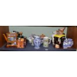 ^ A shelf of modern Rington's china including teapots; Willow pattern blue and white china; a Maling