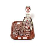 ^ A ruby flash glass liqueur set comprising decanter and stopper, decorated with a bird amongst