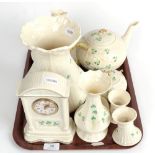 ^ A tray of Belleek china comprising: mantle clock; teapot; two cups and saucers; sugar bowl; salt