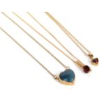 Two garnet pendants on 9 carat gold chains, chain lengths 41cm and 45cm; and a 9 carat gold lapis