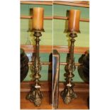 ^ A pair of Victorian brass candlesticks, 54cm high