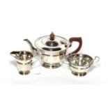 A silver three piece tea service, Collingwood & Sons, Birmingham 1935, circular with bead border,