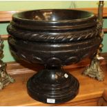 ^ A carved black marble planter, 45cm diameter