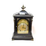 A Victorian quarter striking ebonised table clock, movement back plate stamped W&H, quarter striking