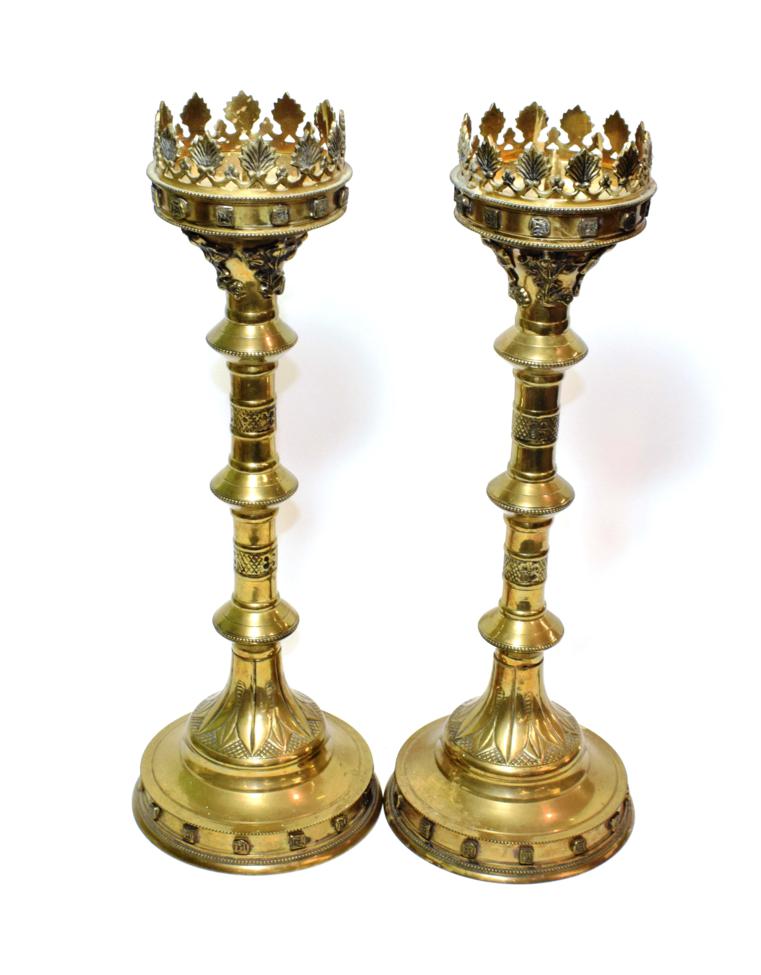 ^ A pair of brass ecclesiastical candlesticks, 50cm high