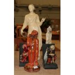 An early 20th century orange drip glazed monkey figure; a pair of plaster bookends and a grotesque