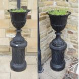 ^ A pair of black painted cast metal pedestal garden urns, 42cm by 124cm
