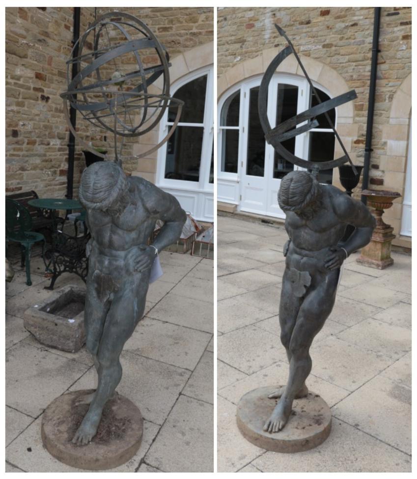 ^ A pair of reproduction metal garden ornaments modelled as male figures holding an armillary