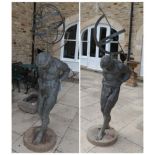 ^ A pair of reproduction metal garden ornaments modelled as male figures holding an armillary