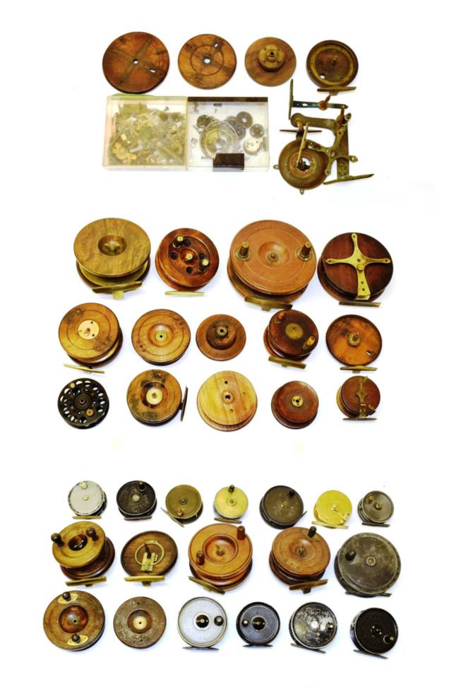 An accumulation of part-restored fishing reels, including a quantity of Nottingham-type examples