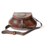 A good 18th century leather pot-bellied fishing creel, the hinged cover tooled with a sunburst